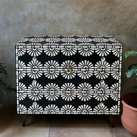 Black bone inlay sideboard with 3 drawers and floral pattern, styled in a rustic setting with indoor plants