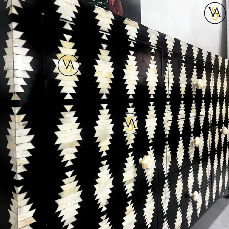 Close-up of the handcrafted bone inlay pattern on black sideboard