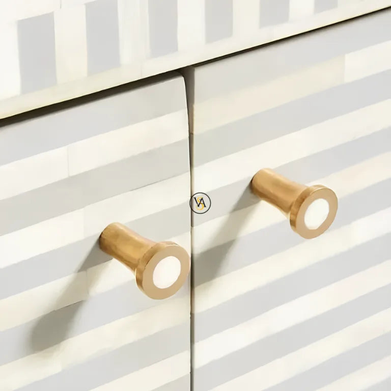 Brass knobs on a gray bone inlay buffet with horizontal stripes