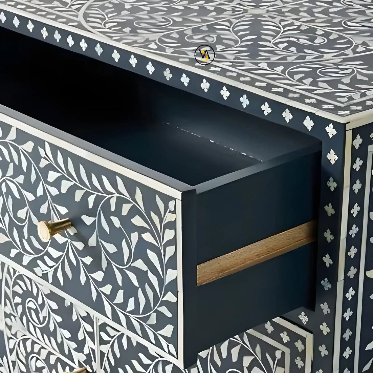 Drawer detail with brass knob and floral inlay design