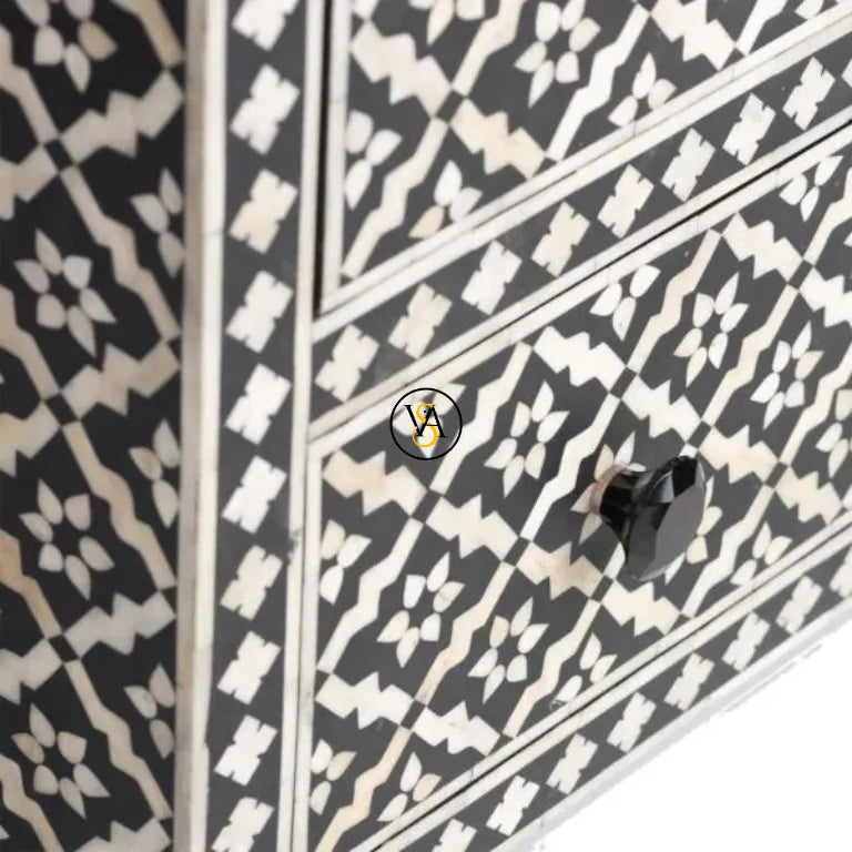 Close-up of intricate floral bone inlay craftsmanship on drawer front