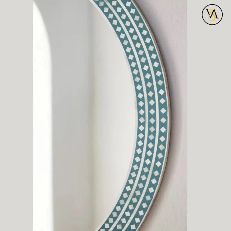 Decorative mirror border with a blue and white geometric pattern on a light gray background