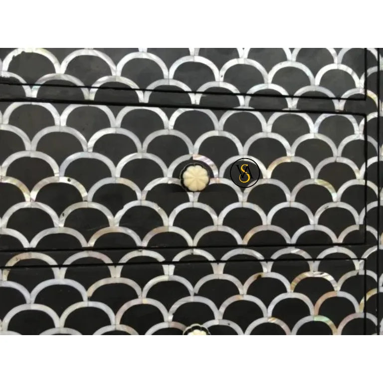 Close-up showing shimmering fish scale mother of pearl inlay and knob design