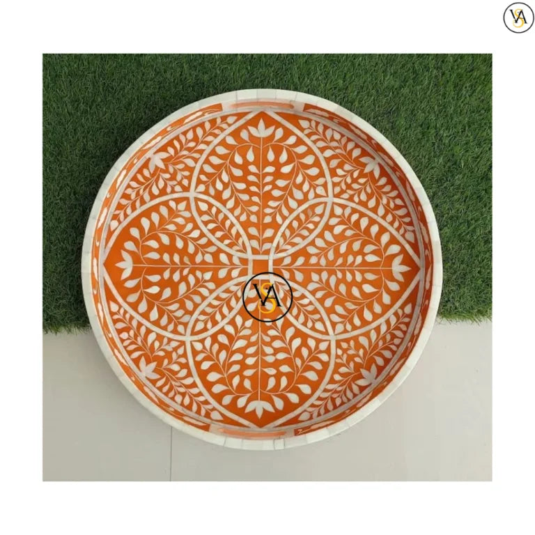 Handmade orange bone inlay tray on artificial grass