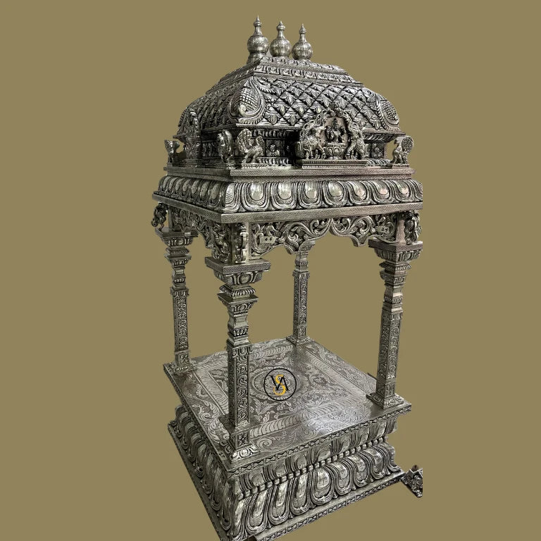Rear angle of white metal temple highlighting embossed floral and deity motifs.