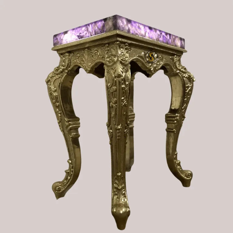 Detailed view of gold brass carved legs under the amethyst top