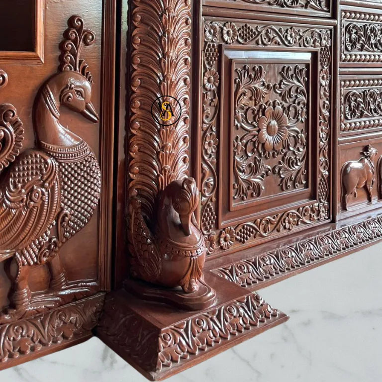 Intricate peacock carving on wooden pooja mandir