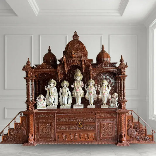 Carved wooden temple with statues on a white background