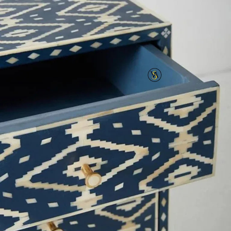 Blue and white patterned drawer with a brass handle on a white background