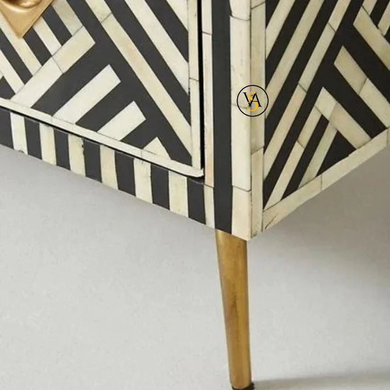 Bone inlay buffet cabinet with black and white geometric pattern and brass legs on a plain background