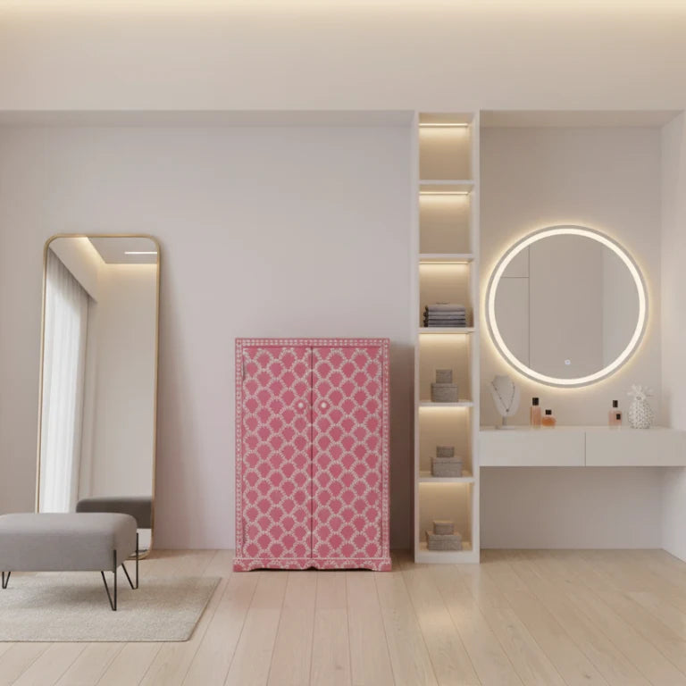 Bone Inlay Pink Cupboard placed in modern dressing room with a round wall mirror and cushioned sofa.