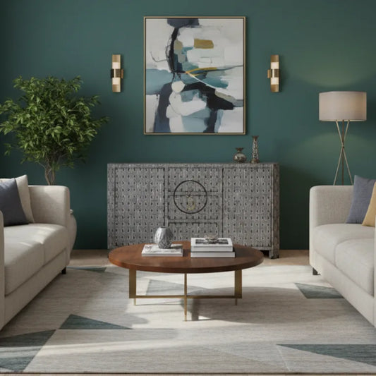 Bone inlay sideboard in modern living room with gray sofas, a round wooden coffee table, and abstract art on the wall.