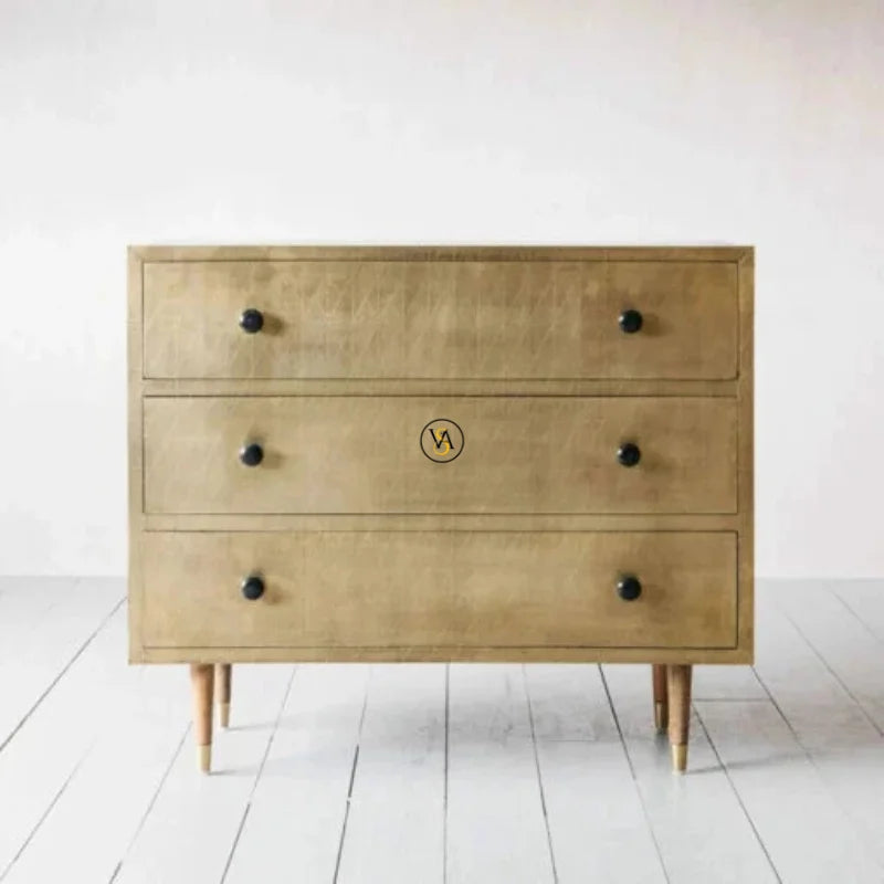 Front view of brass cladding 3 drawer chest with geometric pattern
