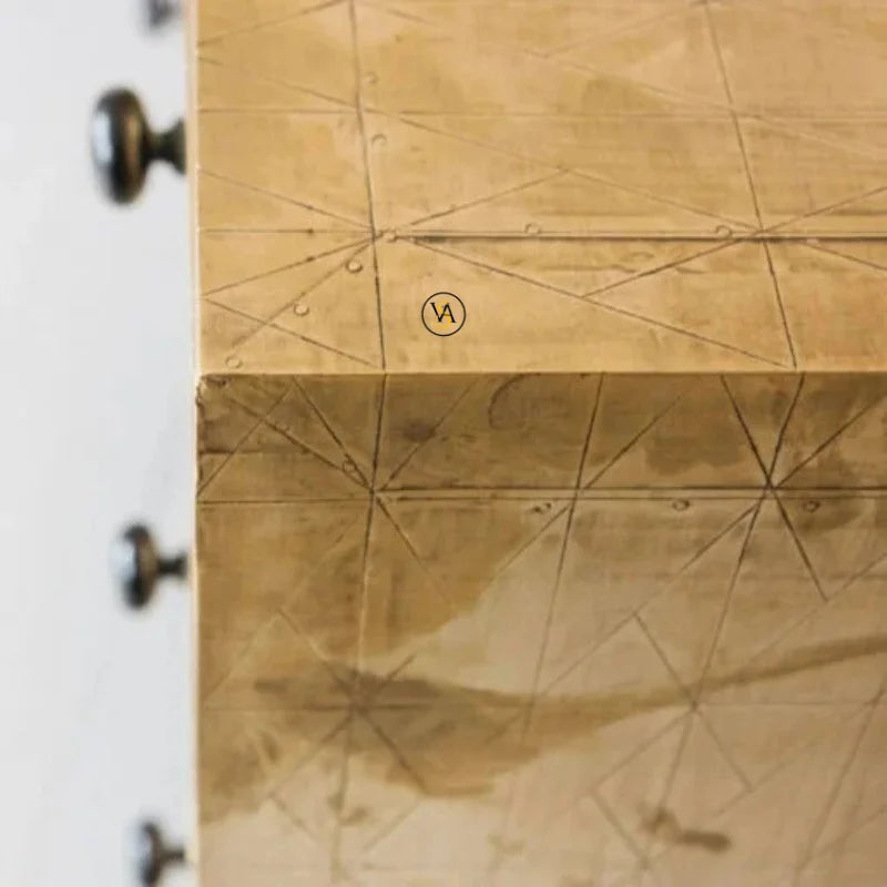 Close up of geometric brass cladding pattern on chest of drawers