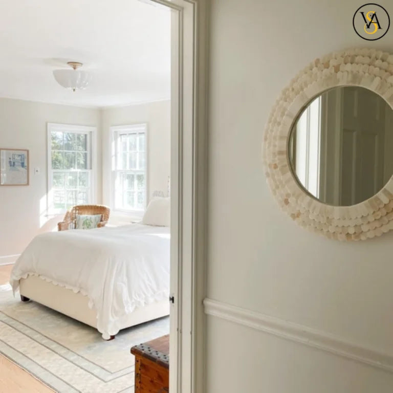 Decorative mirror on a wall with a bedroom in the background