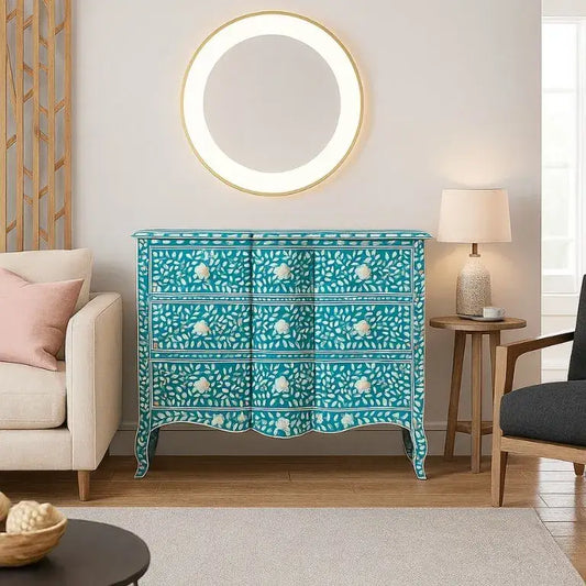 Wave patterned dresser in a living room setting with a round mirror above it.