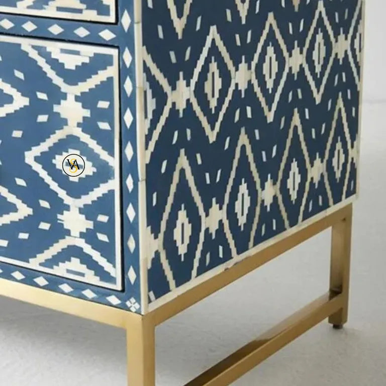 Dresser with blue and white geometric pattern and brass legs on a white background