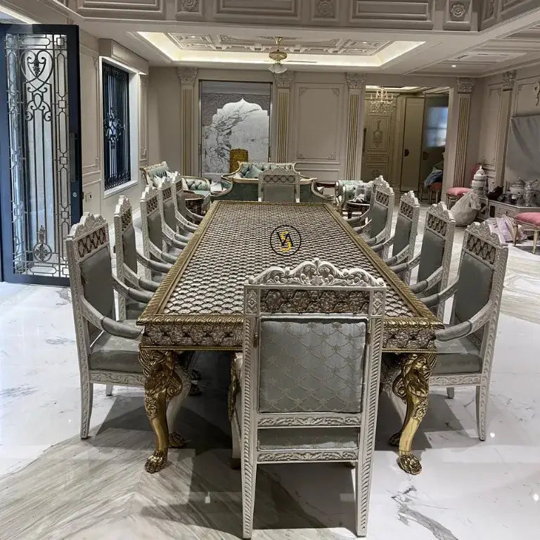 Luxury dining table with ornate chairs in a luxurious living room.