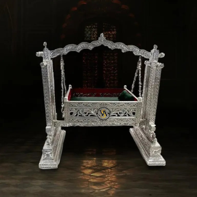 Luxury Silver Baby Jhula with red cushion on a dark background