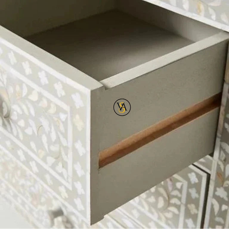 Open drawer of a piece of furniture with a decorative patterned design.
