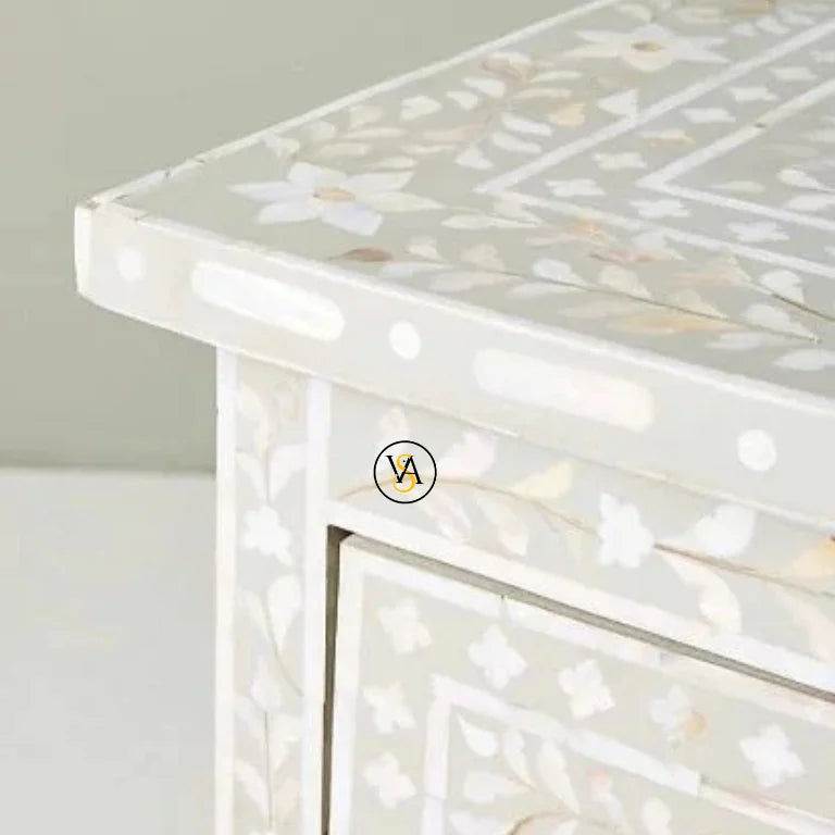 Close-up of a decorative table with a shell inlay design.
