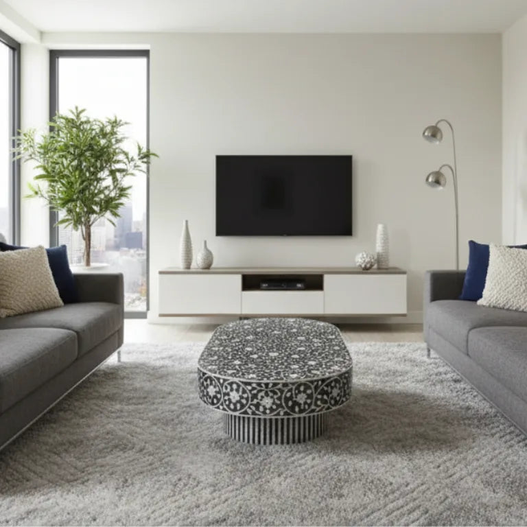 Handcrafted Mother of Pearl Gray Coffee Table with Star Floral Pattern in modern living room with a gray sofa, and Led Tv on a light beige wall.