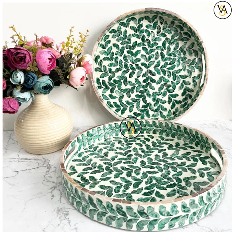 Round mother of pearl inlay tray with green leaf pattern on marble background