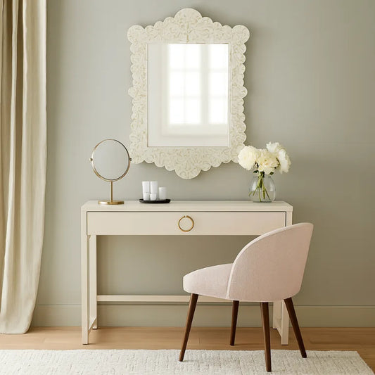 Neatly arranged room with a white desk, decorative mother of pearl mirror, and chair.