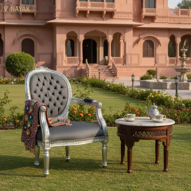 Royal French style vintage silver chair with a colorful blanket and coffee table in front of a palace